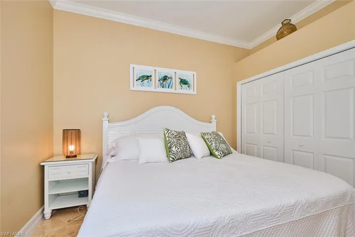 Bedroom featuring crown molding and a closet