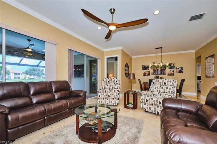 Living area with crown molding, ceiling fan, and recessed lighting