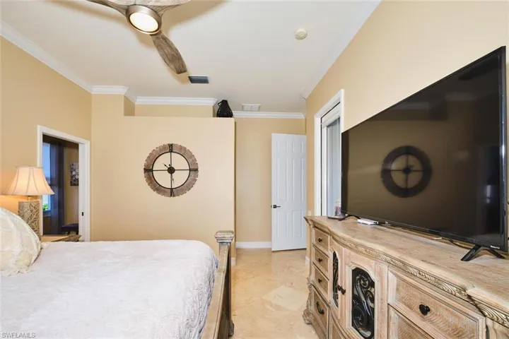 Bedroom with crown molding and ceiling fan