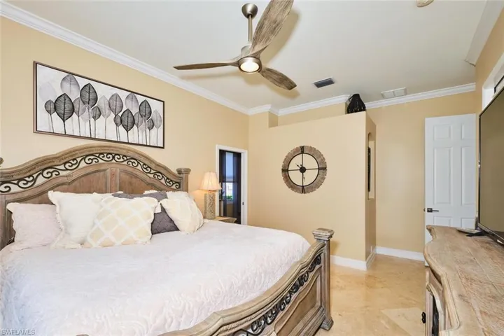 Bedroom featuring crown molding and a ceiling fan