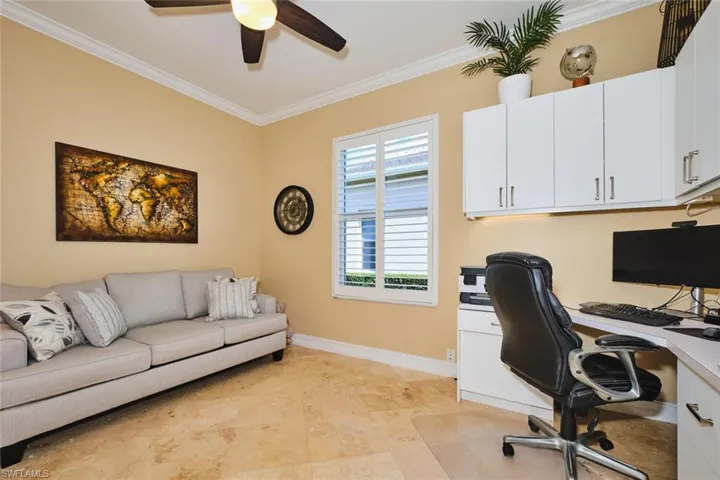 Office space with crown molding and ceiling fan