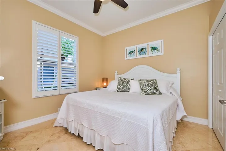 Bedroom with crown molding, a closet, and a ceiling fan