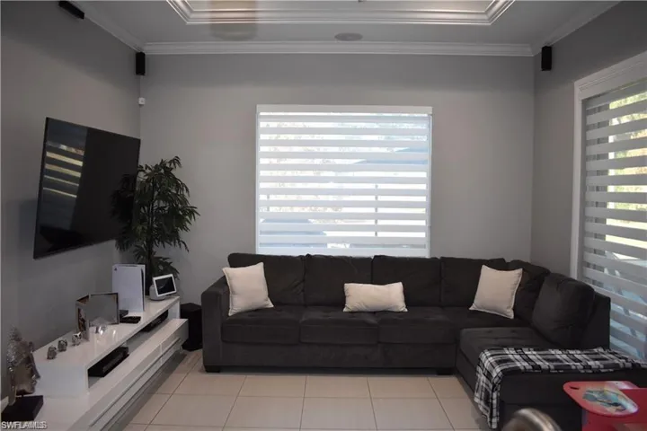 Tiled living area with crown molding