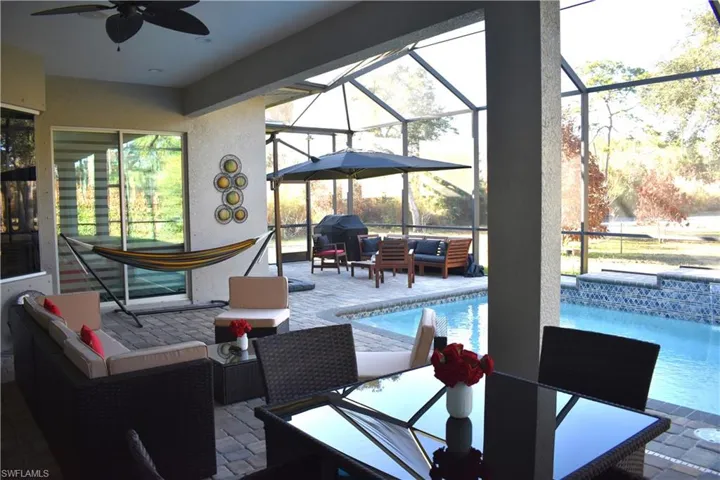 View of patio featuring outdoor lounge area, an outdoor pool, a sunroom, a lanai, and ceiling fan