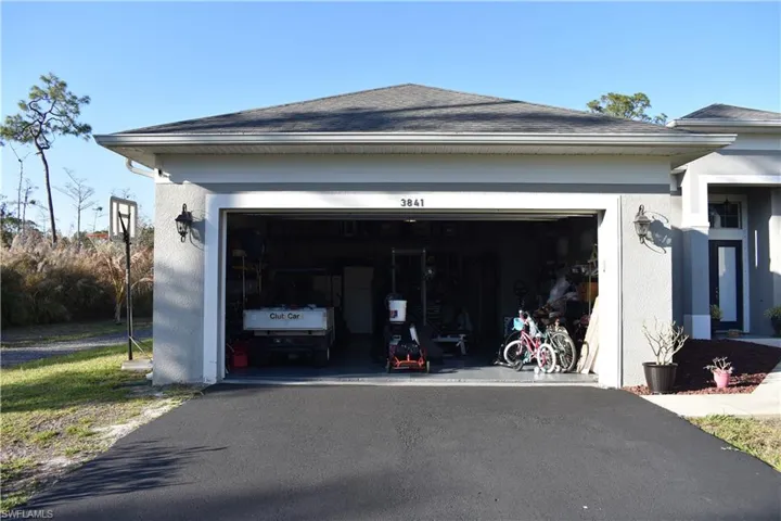 Garage with asphalt driveway
