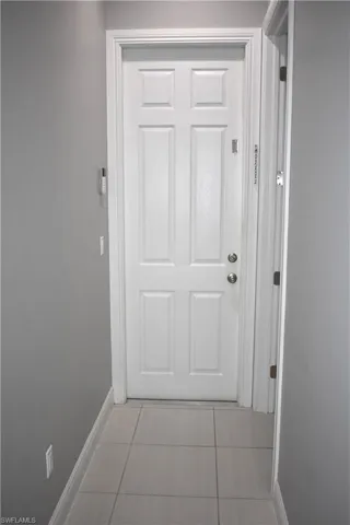 Entryway with baseboards and tile patterned flooring
