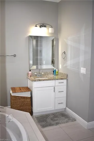 Bathroom featuring vanity and light tile patterned flooring