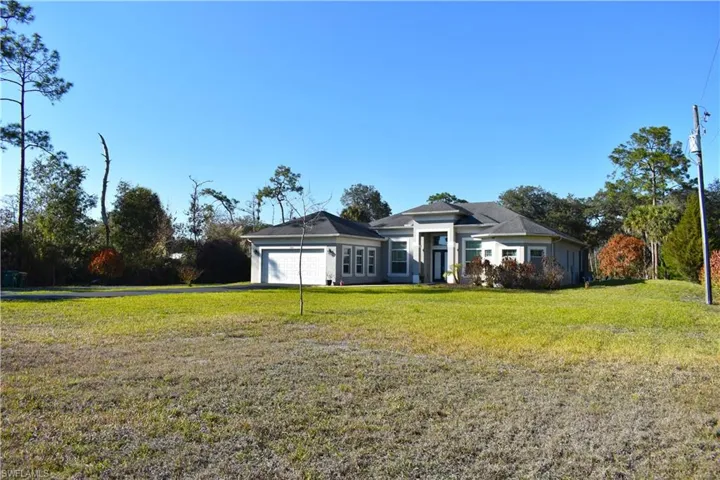 View of front of home featuring a front yard and an attached garage