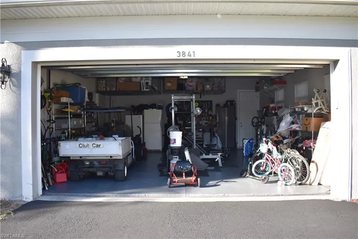 Garage featuring freestanding refrigerator