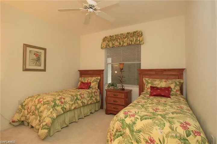 Carpeted bedroom with ceiling fan