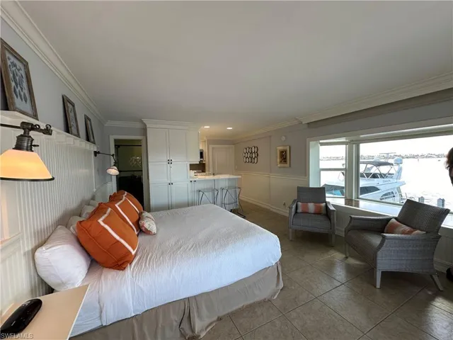 Bedroom featuring tile patterned floors and ornamental molding