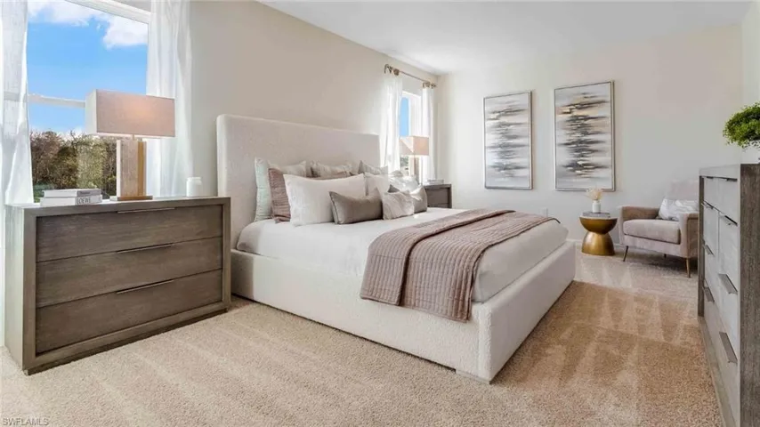 Neutral-toned carpeted flooring, large windows with natural light, and a neutral wall palette