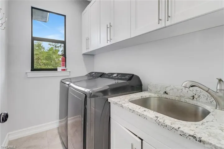 Laundry area featuring cabinet space and independent washer and dryer