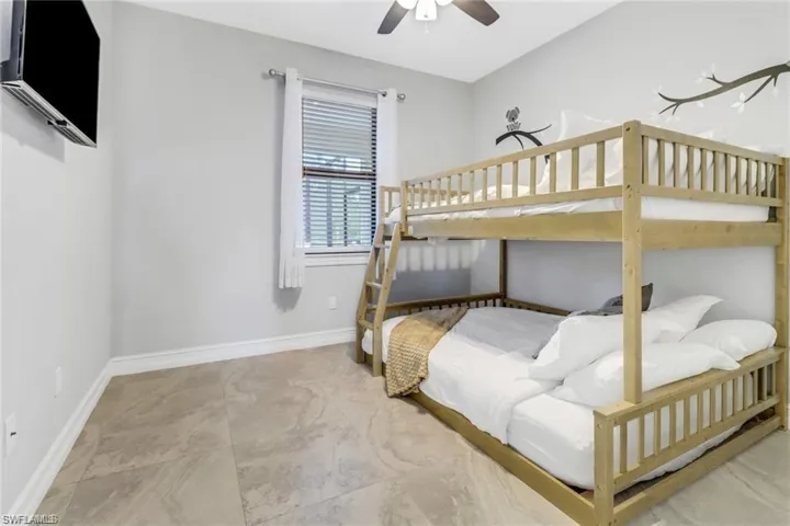 Bedroom featuring baseboards and ceiling fan