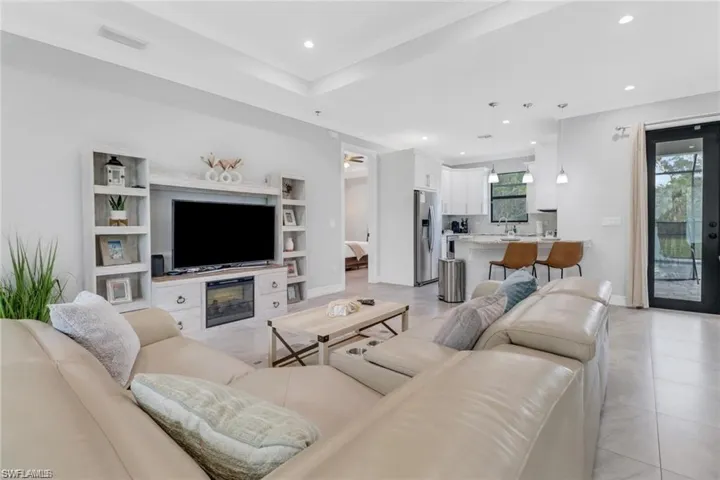 Living area featuring recessed lighting and light tile patterned floors