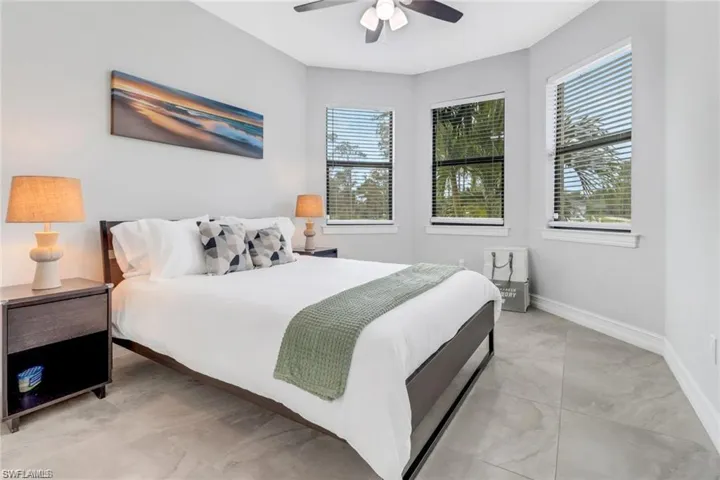 Bedroom with ceiling fan and baseboards