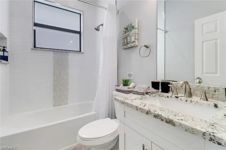 Bathroom with vanity and shower / tub combo