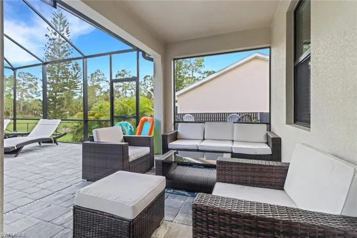 View of patio / terrace with an outdoor lounge area, a sunroom, and a lanai