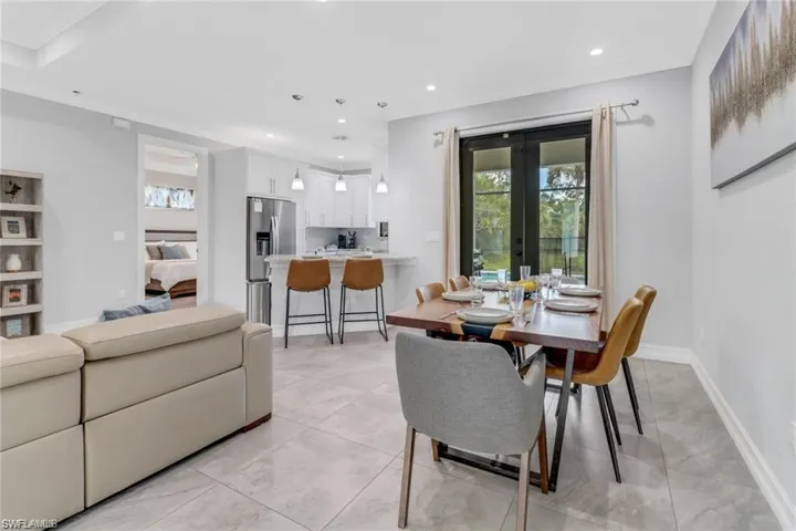 Dining space featuring plenty of natural light, recessed lighting, and french doors