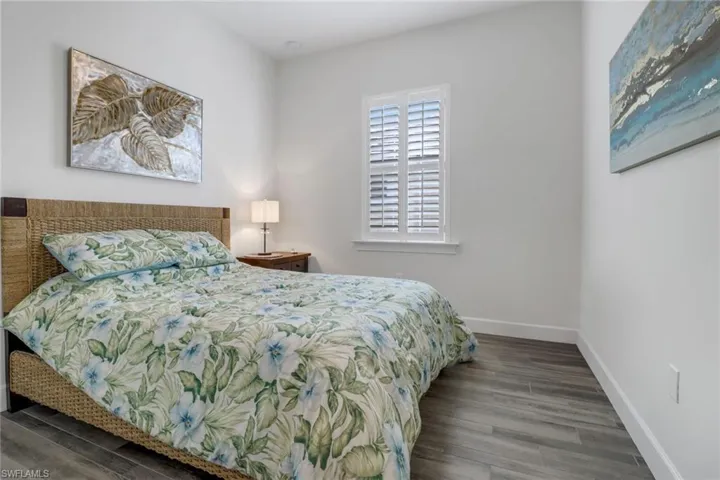 Bedroom featuring baseboards and wood finished floors