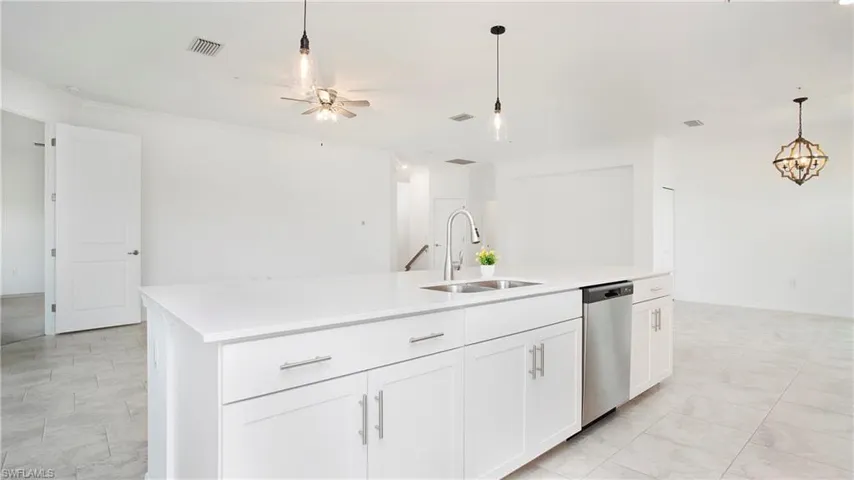 Modern kitchen island with integrated sink and stainless steel dishwasher