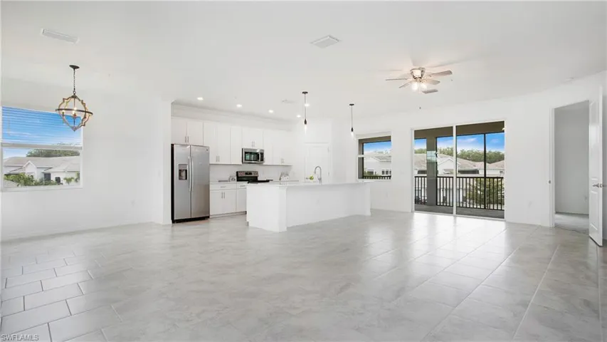 Open-concept living space with light-toned tiled flooring