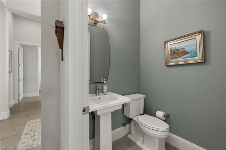 Bathroom with hardwood / wood-style floors and toilet