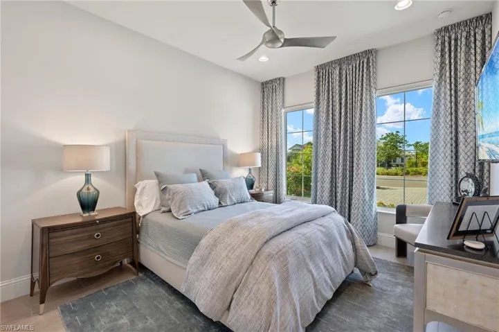 Bedroom featuring ceiling fan and dark hardwood / wood-style floors