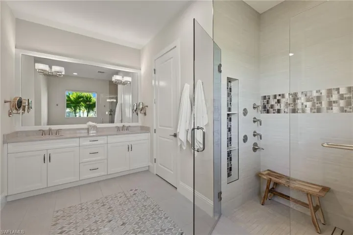 Bathroom with vanity, tile patterned floors, and walk in shower