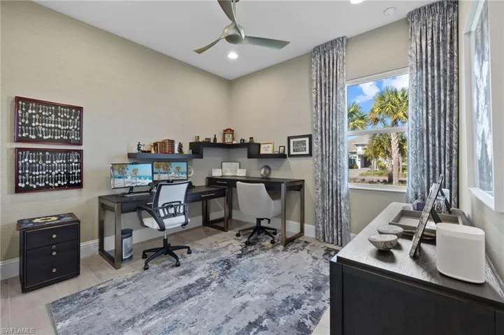 Home office featuring ceiling fan and light hardwood / wood-style floors