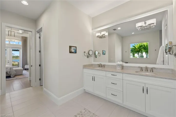 Bathroom with tile patterned floors and vanity