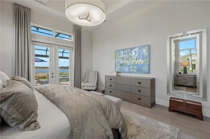 Bedroom featuring access to outside, french doors, and light hardwood / wood-style floors