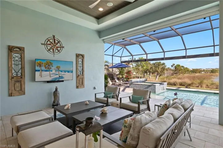 View of patio / terrace with a swimming pool with hot tub, an outdoor hangout area, glass enclosure, and ceiling fan