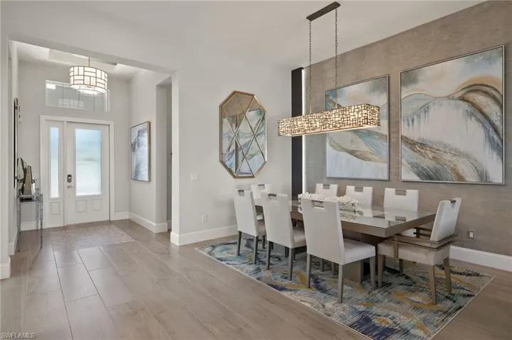 Dining area featuring wood-type flooring and a notable chandelier