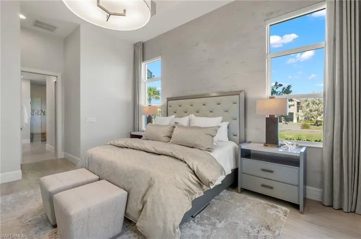 Bedroom featuring light hardwood / wood-style floors and multiple windows
