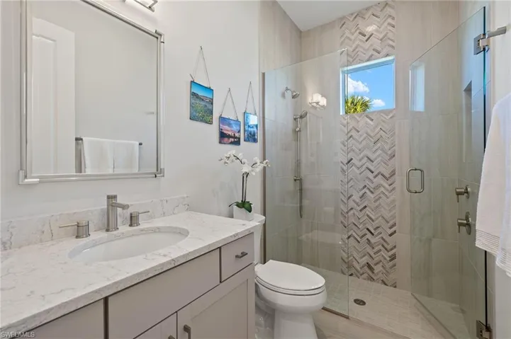 Bathroom with vanity, toilet, and walk in shower
