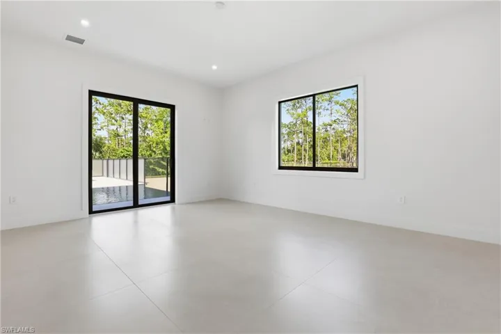 Empty room featuring baseboards and recessed lighting