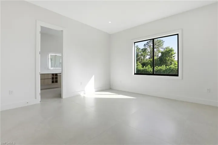 Unfurnished room with baseboards