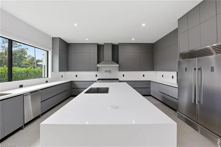 Kitchen with gray cabinets, stainless steel appliances, modern cabinets, and recessed lighting
