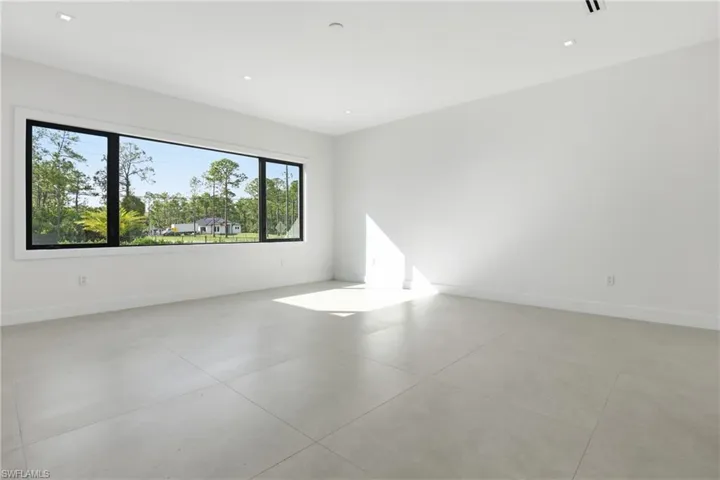 Empty room featuring baseboards and recessed lighting