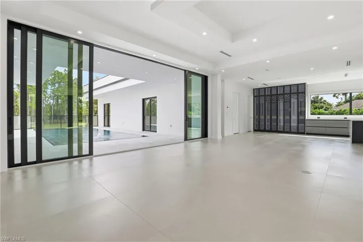 Empty room with a raised ceiling and recessed lighting