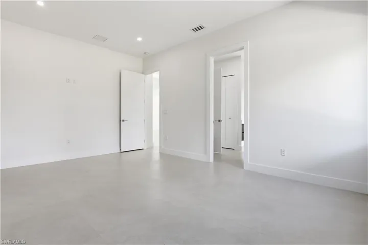 Spare room featuring concrete flooring and recessed lighting