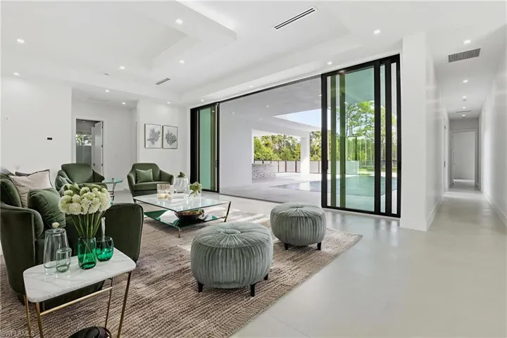 Living room with recessed lighting and a tray ceiling