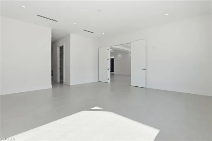 Spare room with finished concrete floors and recessed lighting