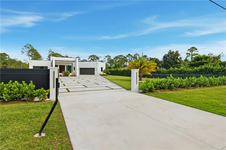 Modern home featuring stucco siding and driveway