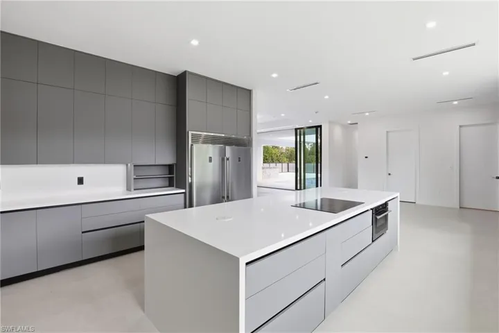 Kitchen with gray cabinetry, a large island, modern cabinets, stainless steel appliances, and recessed lighting