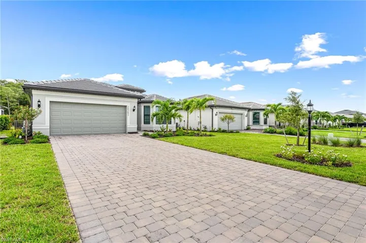Ranch-style house with a front lawn and a garage
