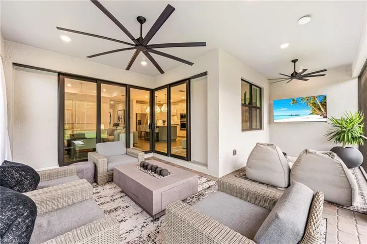 View of patio / terrace with an outdoor living space with a fire pit and ceiling fan