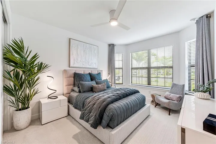 Carpeted bedroom with ceiling fan