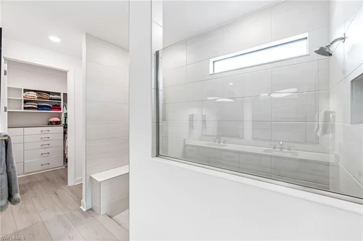 Bathroom featuring hardwood / wood-style flooring and tiled shower
